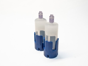 Single-use medical infusion pumps with blue holders, used for safe drug delivery in clinical settings.
